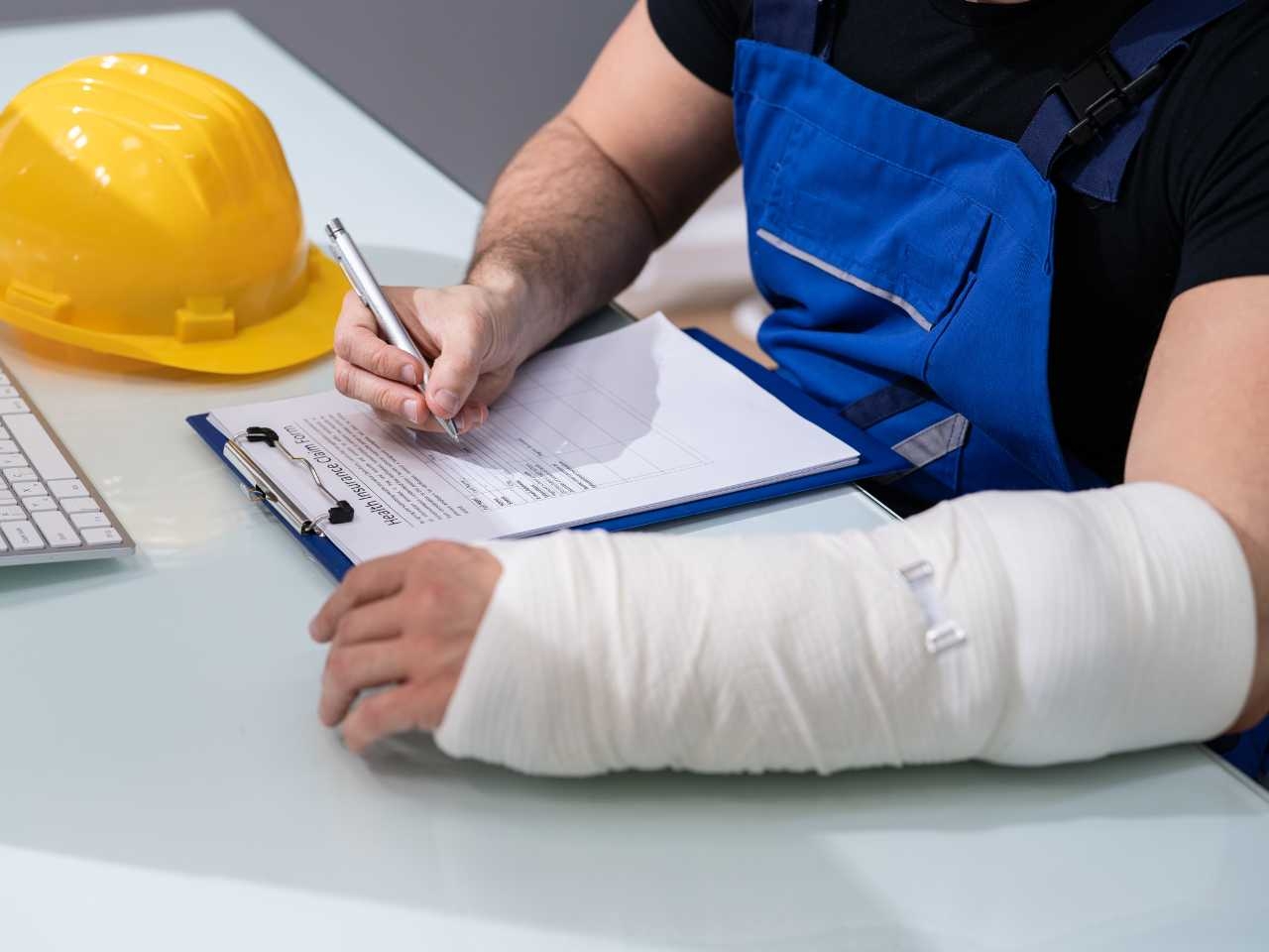 a construction employee with a broken arm fills out a written form